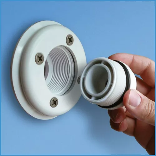Removing a skimmer plug from the pool during the pool opening process.
